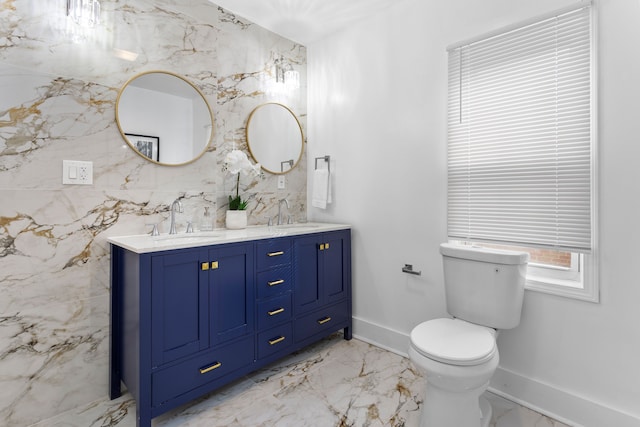 bathroom with vanity, toilet, and tile walls