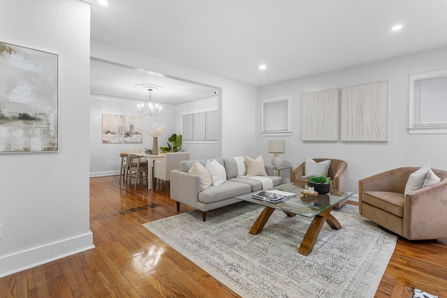 living room featuring a chandelier and hardwood / wood-style flooring