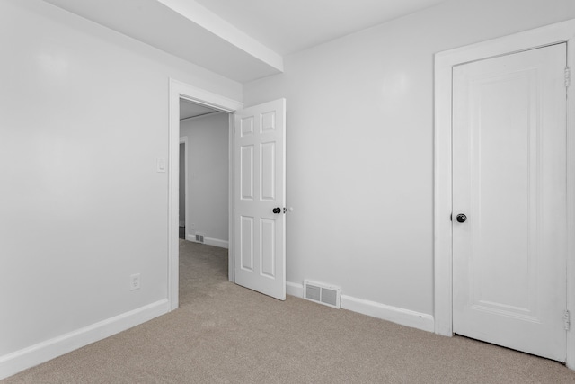 unfurnished bedroom featuring light colored carpet