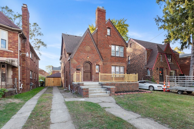 english style home with a front yard