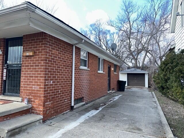 view of side of property featuring an outbuilding and a garage