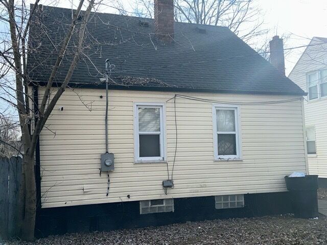 20543 Waltham St, Detroit, MI 48205 - view of side of home with a chimney and a shingled roof