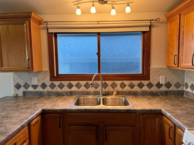 kitchen featuring white range oven, sink, and tasteful backsplash