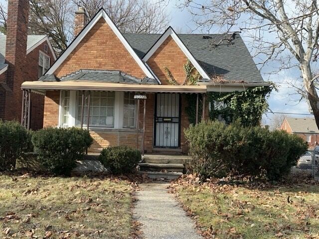 17401 W Albion St W, Detroit, MI 48234 - bungalow featuring roof with shingles, brick siding, and a chimney