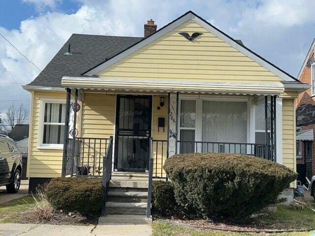 17665 Runyon St, Detroit, MI 48234 - bungalow with a chimney, covered porch, and roof with shingles