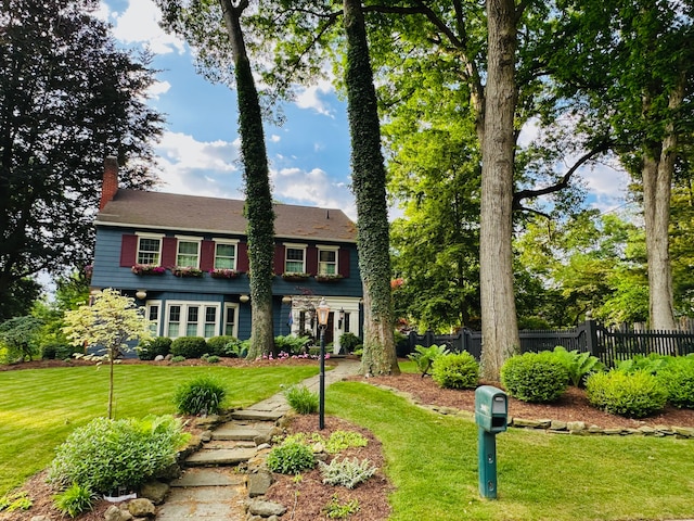 colonial home with a front lawn