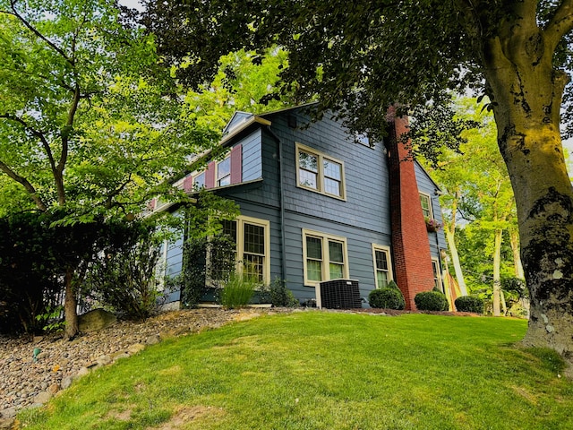 rear view of property with a yard