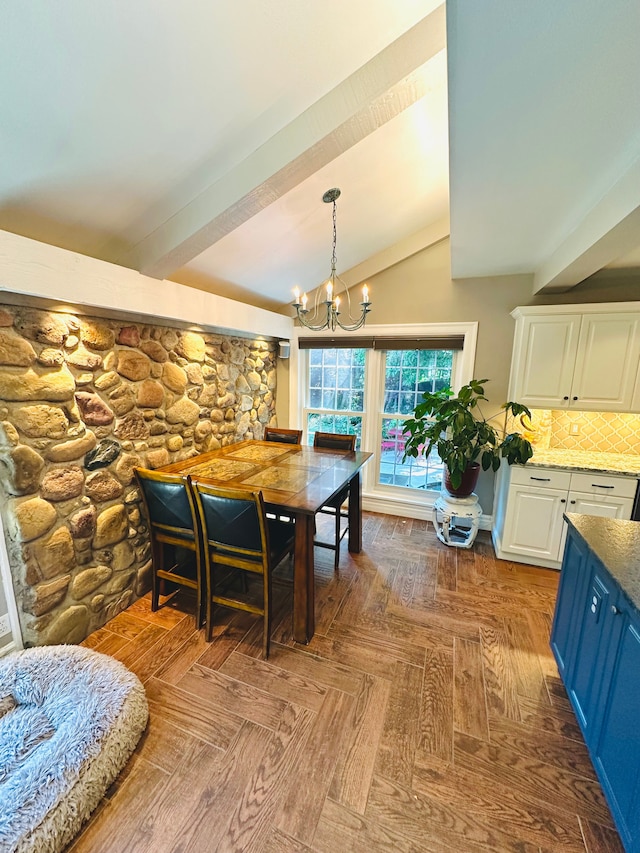 dining space featuring lofted ceiling, parquet flooring, and an inviting chandelier