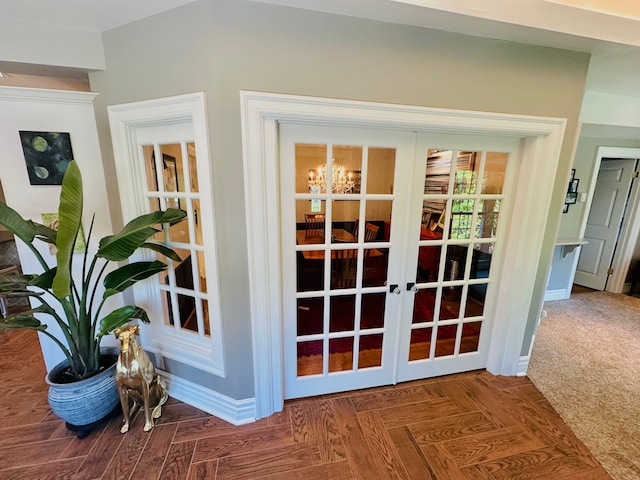 entryway with french doors and an inviting chandelier