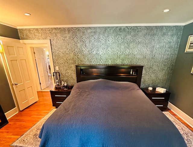 bedroom featuring hardwood / wood-style flooring and ornamental molding