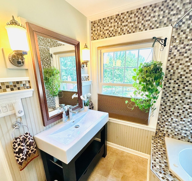 bathroom featuring tiled shower and vanity