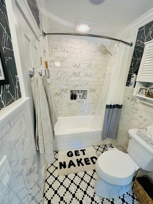 bathroom featuring shower / bath combo, toilet, ornamental molding, and tile walls