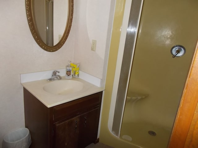 bathroom with an enclosed shower and vanity