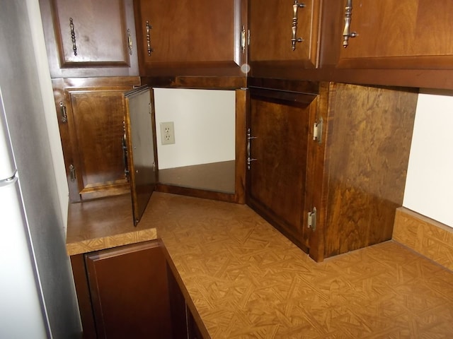 1164 Mary Jane Cir, Caro, MI 48723 - details with freestanding refrigerator and brown cabinets