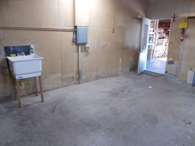 basement with electric panel and sink