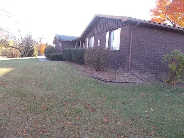 1164 Mary Jane Cir, Caro, MI 48723 - view of side of property featuring brick siding and a lawn