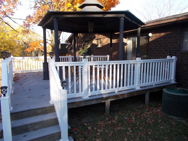 wooden terrace with a gazebo and central AC unit