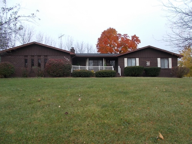 1164 Mary Jane Cir, Caro, MI 48723 - single story home featuring a chimney, a front yard, covered porch, and brick siding