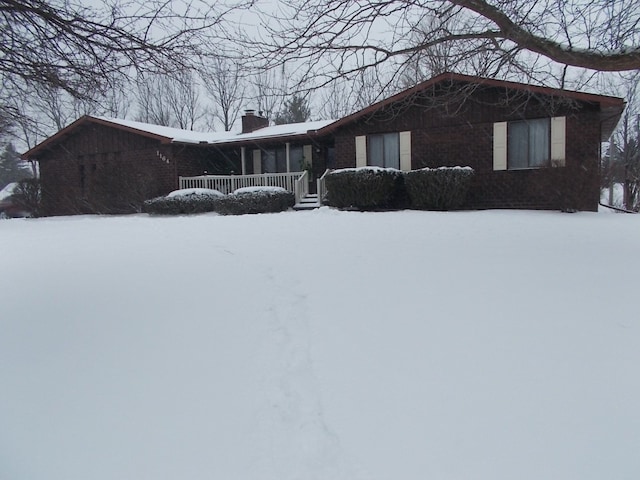1164 Mary Jane Cir, Caro, MI 48723 - view of front facade featuring brick siding and a chimney