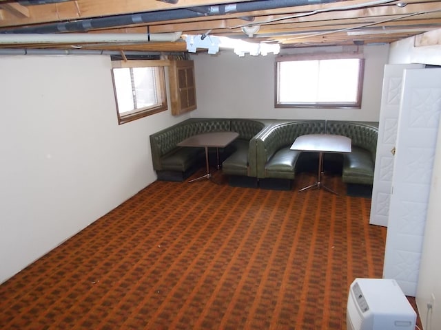 interior space with dark colored carpet and a wealth of natural light