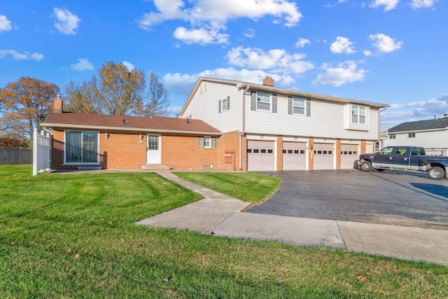 view of property featuring a garage and a front lawn