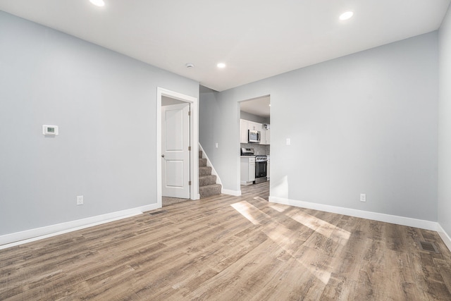 spare room featuring light wood-type flooring