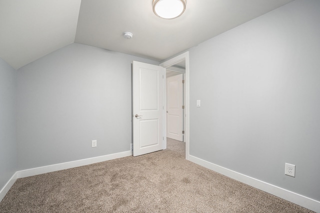 bonus room with light carpet and vaulted ceiling