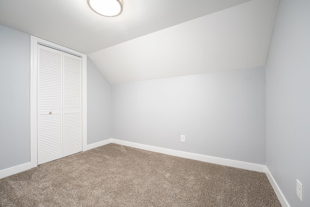 additional living space with carpet flooring and lofted ceiling