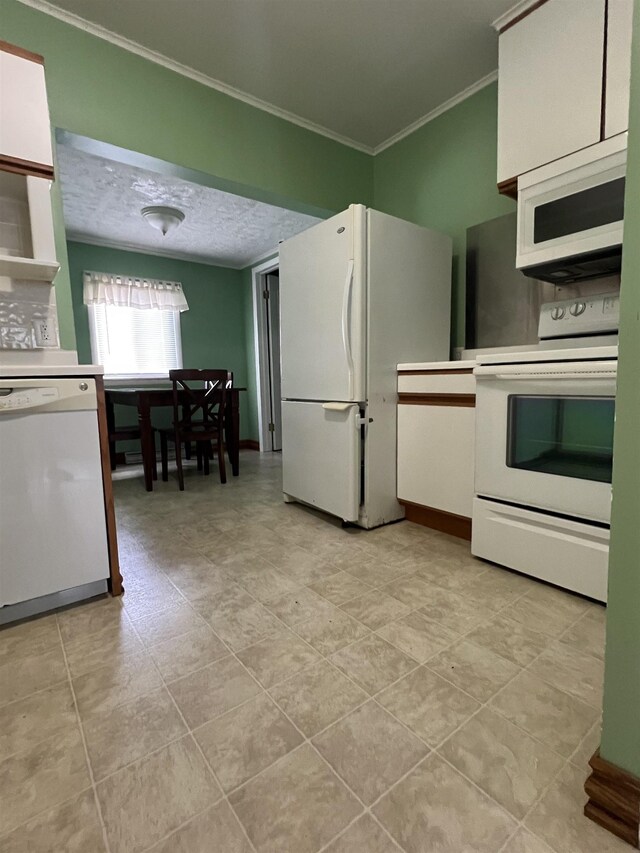 kitchen featuring white cabinetry, white appliances, ornamental molding, and a textured ceiling