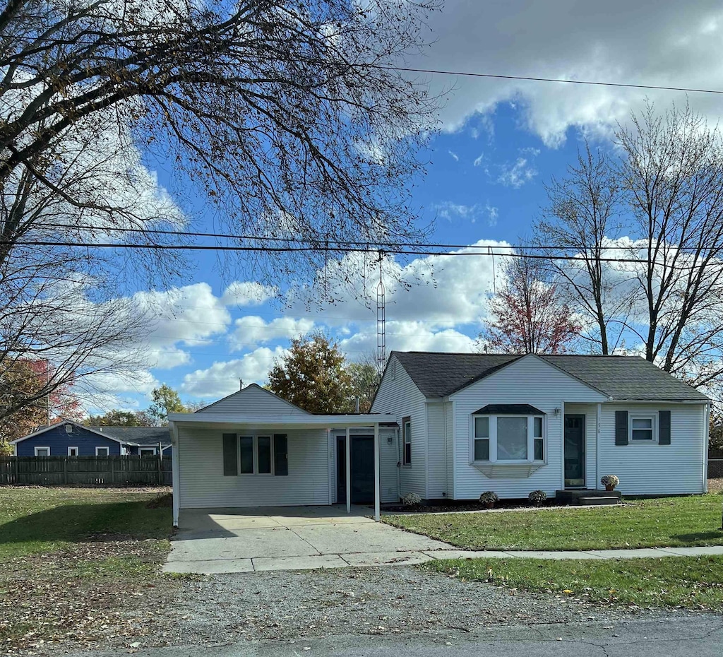 view of front of house with a front lawn and fence