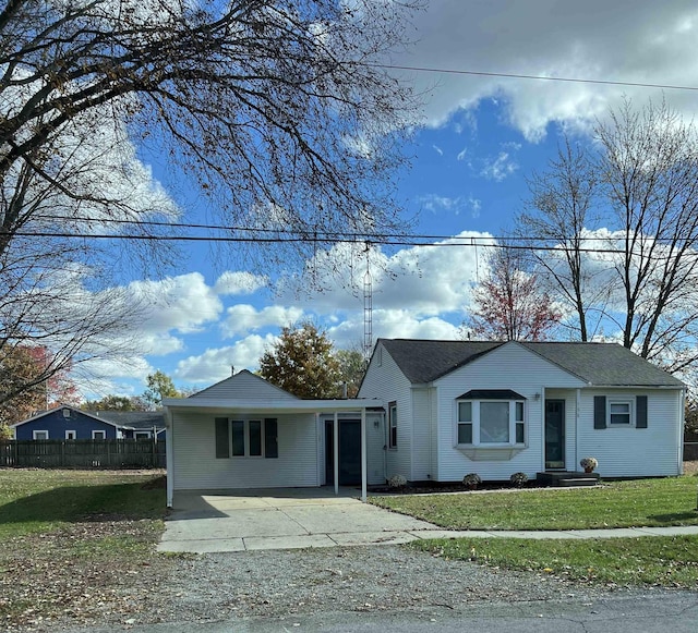 view of front of house with a front lawn and fence