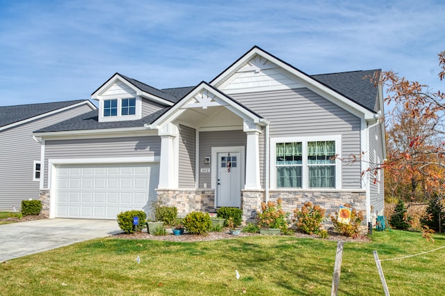 view of front of house featuring a garage and a front lawn