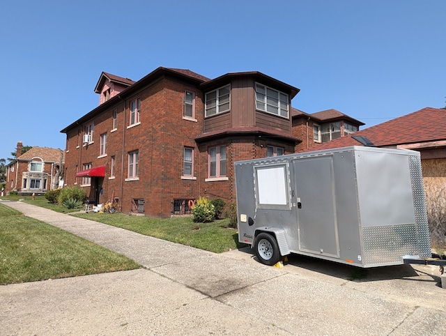 view of side of home with a lawn