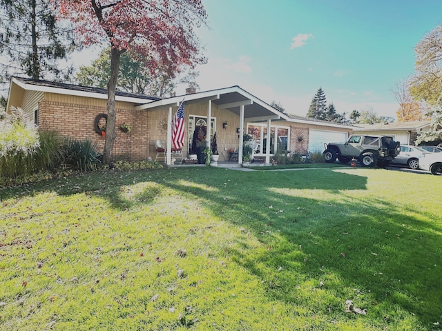 single story home featuring a front lawn and a garage