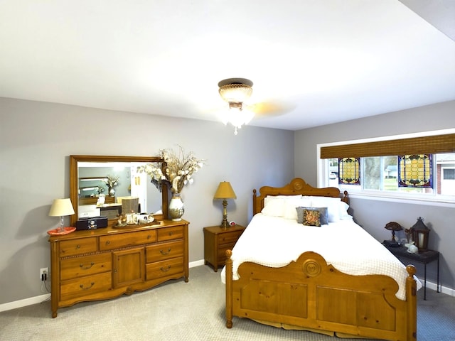 bedroom with ceiling fan and light colored carpet