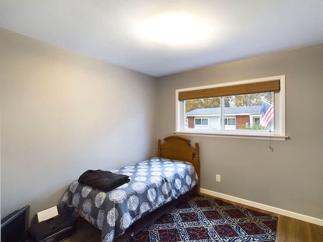 bedroom with dark hardwood / wood-style floors