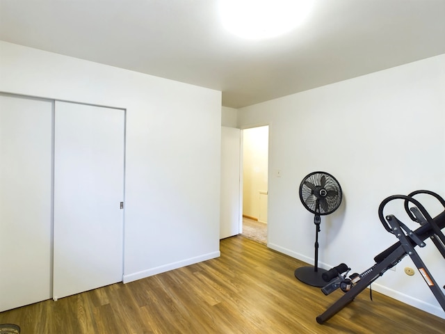 workout area with wood-type flooring