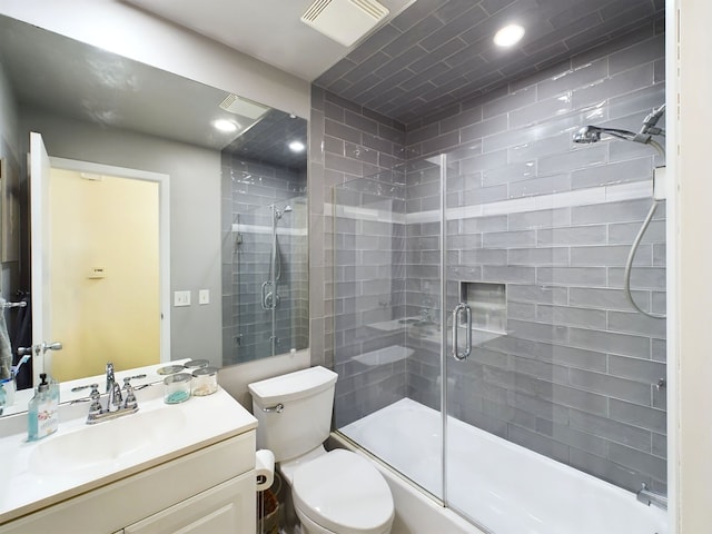 bathroom featuring vanity, toilet, and a shower with door