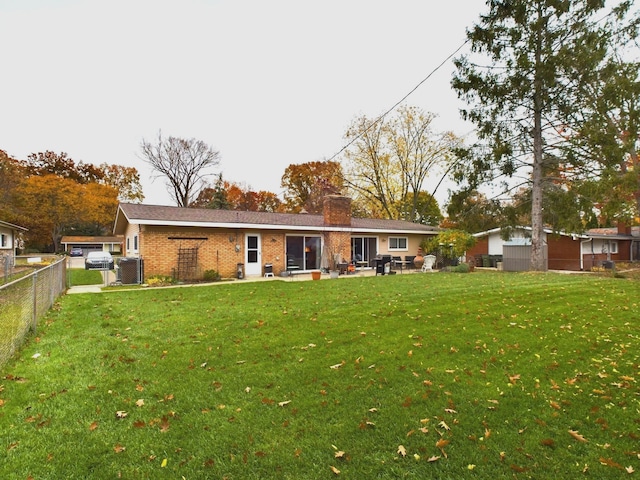 rear view of property featuring a yard and a patio