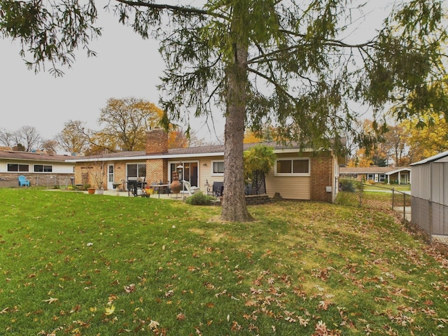 back of house featuring a yard and a patio