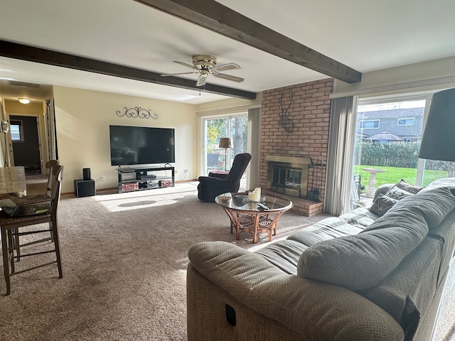 living room with beamed ceiling, carpet flooring, a fireplace, and ceiling fan