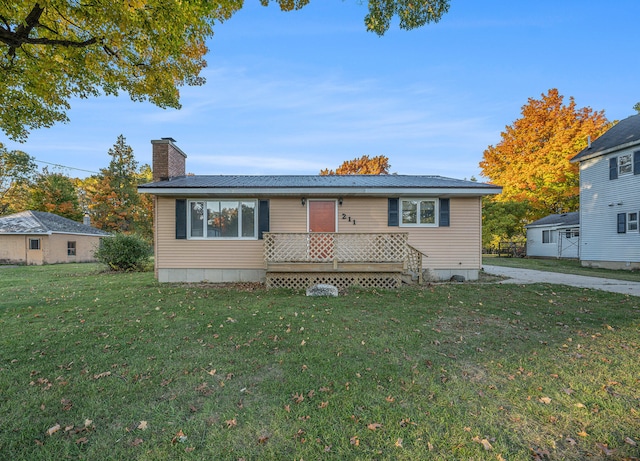 view of front of home featuring a deck and a front lawn