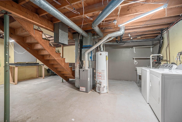 basement with washing machine and dryer, heating unit, and water heater