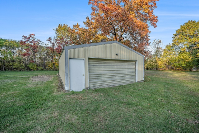 view of outbuilding with a lawn and a garage