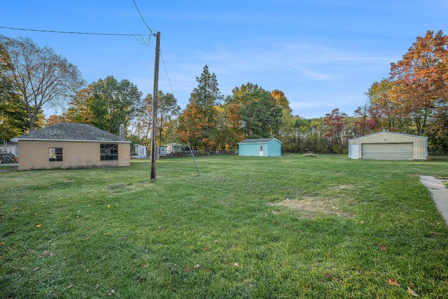 view of yard featuring an outbuilding and a garage