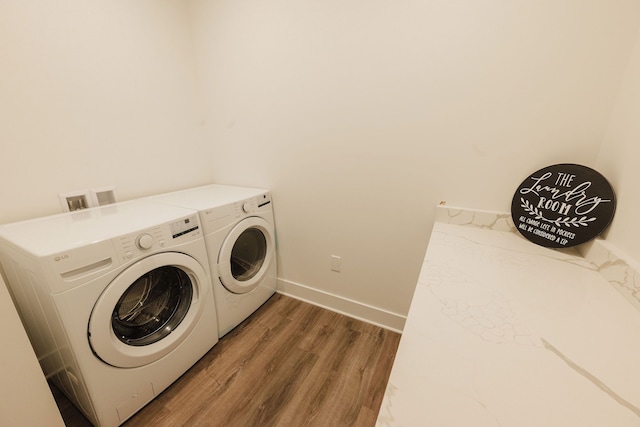 laundry area featuring separate washer and dryer and dark hardwood / wood-style floors