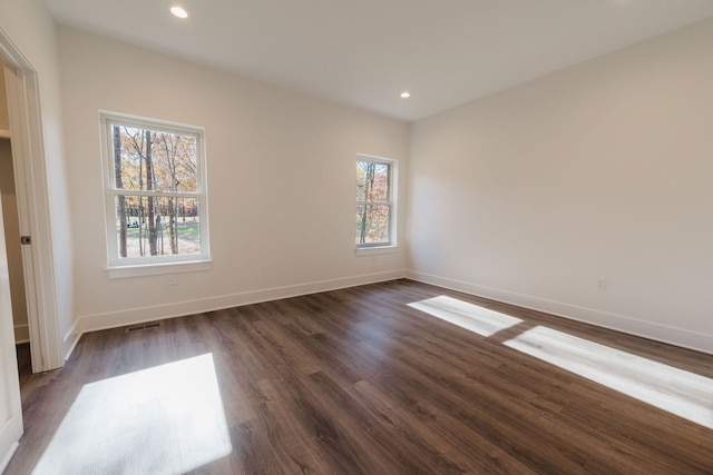 empty room with dark wood-type flooring