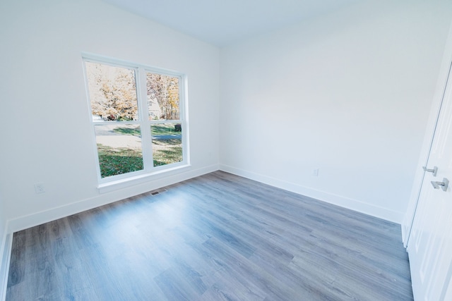 empty room with dark wood-type flooring