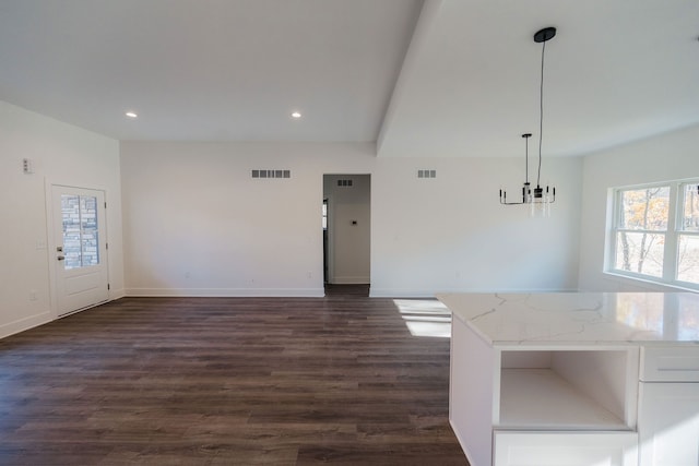 interior space with a chandelier and dark wood-type flooring