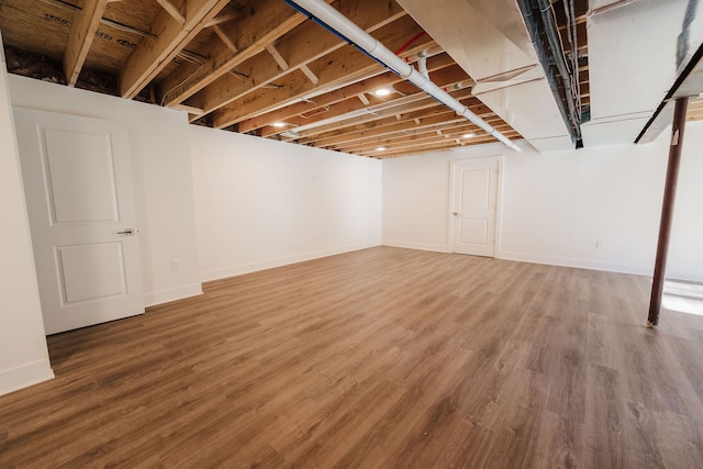 basement with hardwood / wood-style floors